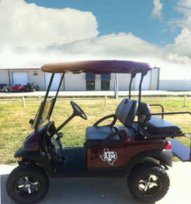 A maroon golf cart