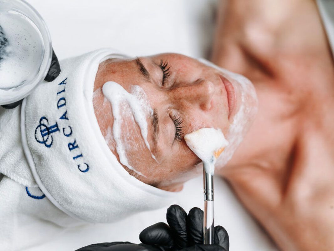 A woman is getting her hair washed in a sink at a salon.