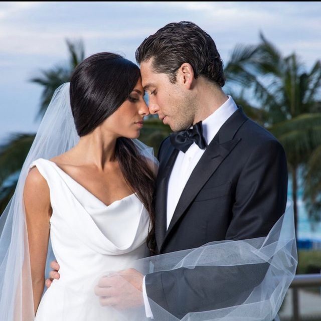 A bride and groom are looking into each other 's eyes