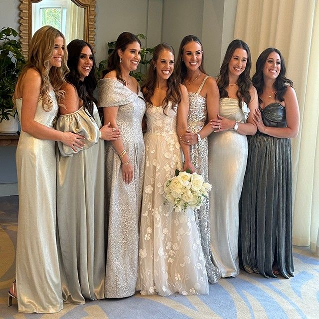 A bride and her bridesmaids pose for a photo