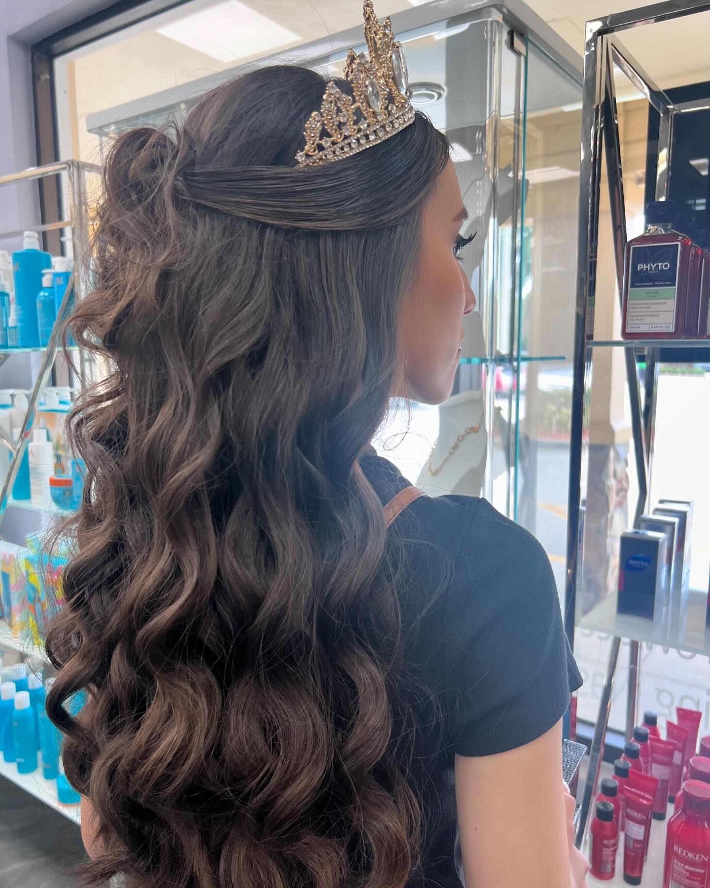 A woman is wearing a tiara on her head.