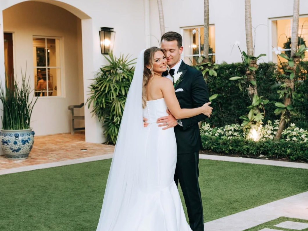 A woman is applying makeup to her face with a brush.