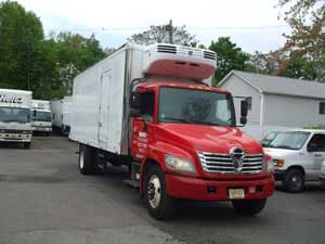 Red and white refrigerated truck