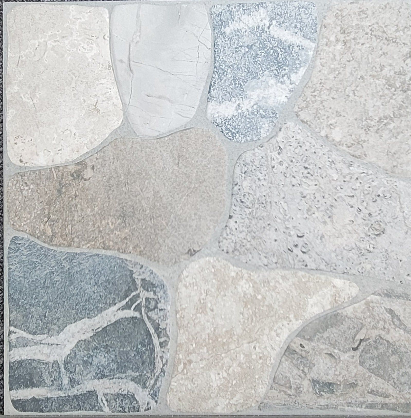 A close up of a tile that looks like rocks