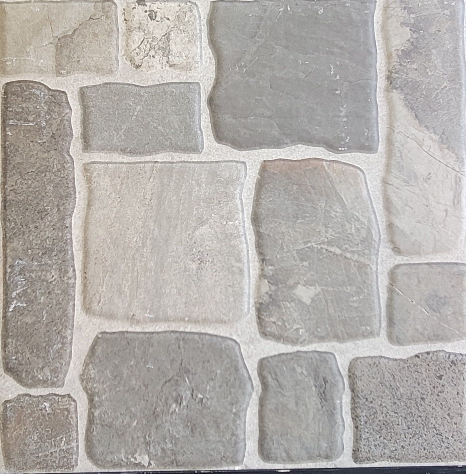 A close up of a tile that looks like a stone wall