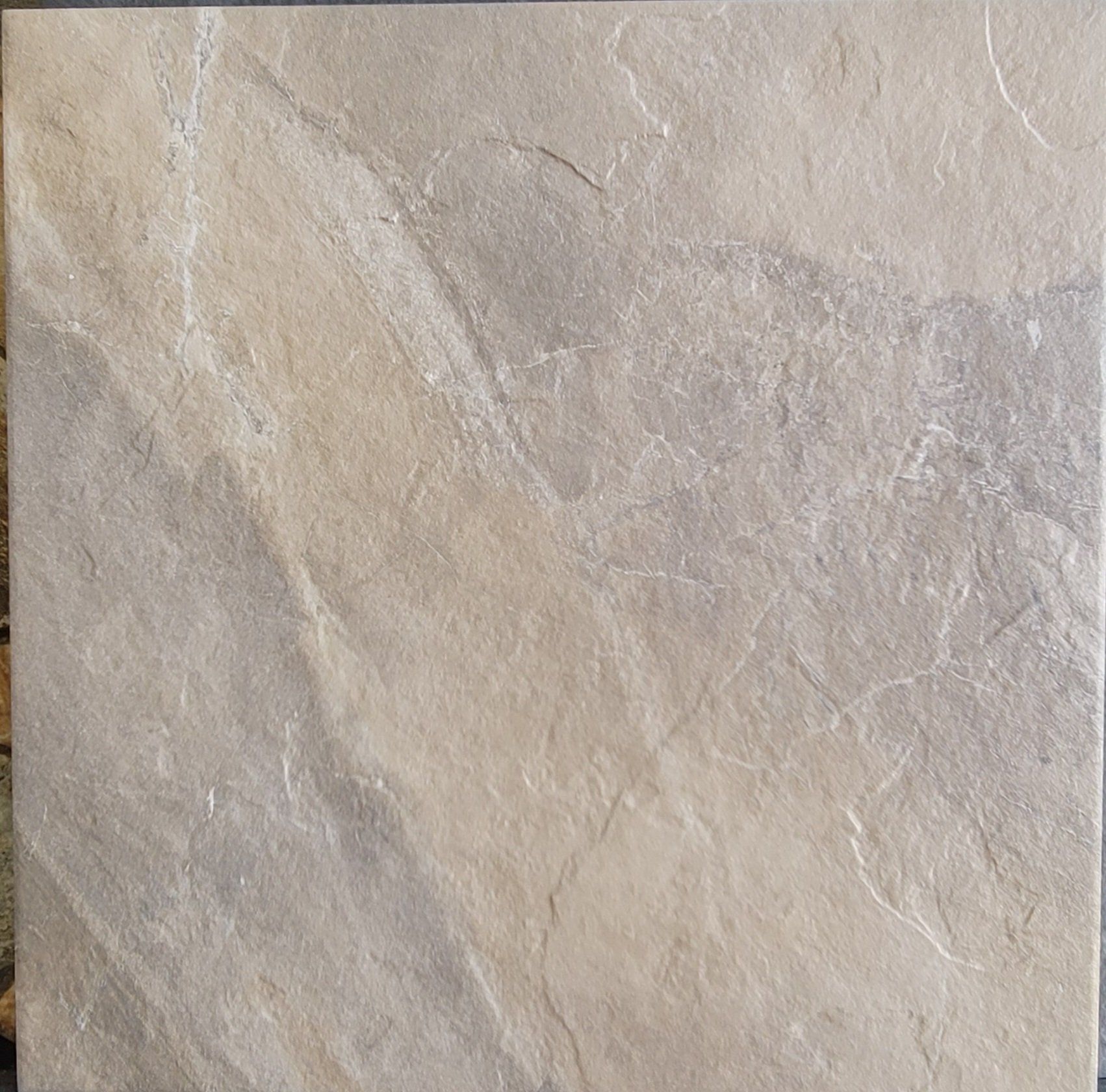 A close up of a tile with a marble texture