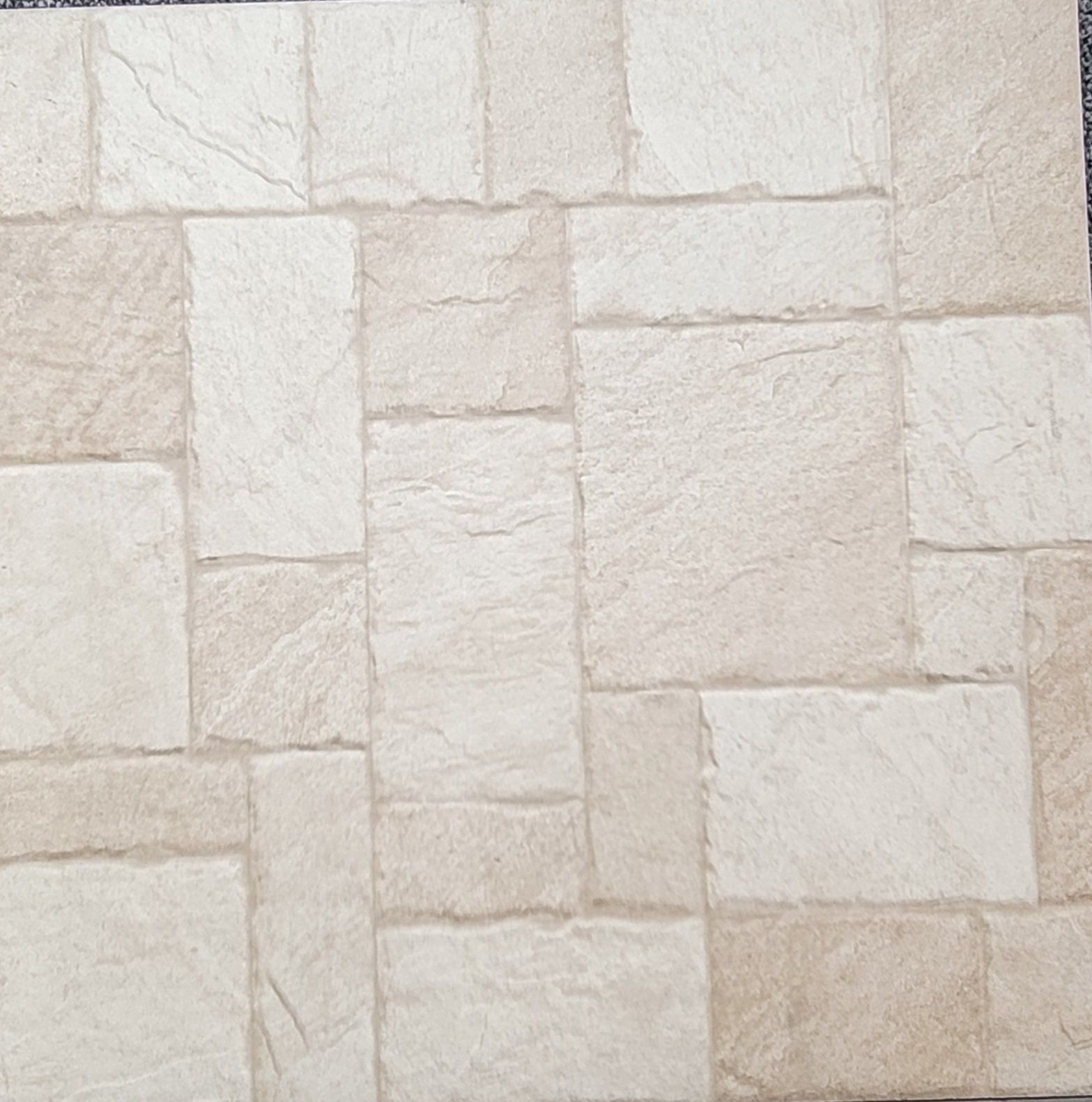 A close up of a tile that looks like a brick wall