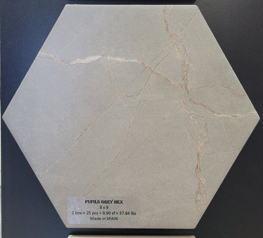 A hexagonal tile with a label that says ' royal grey ella ' on it