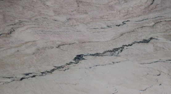 A close up of a white marble counter top with black veins.