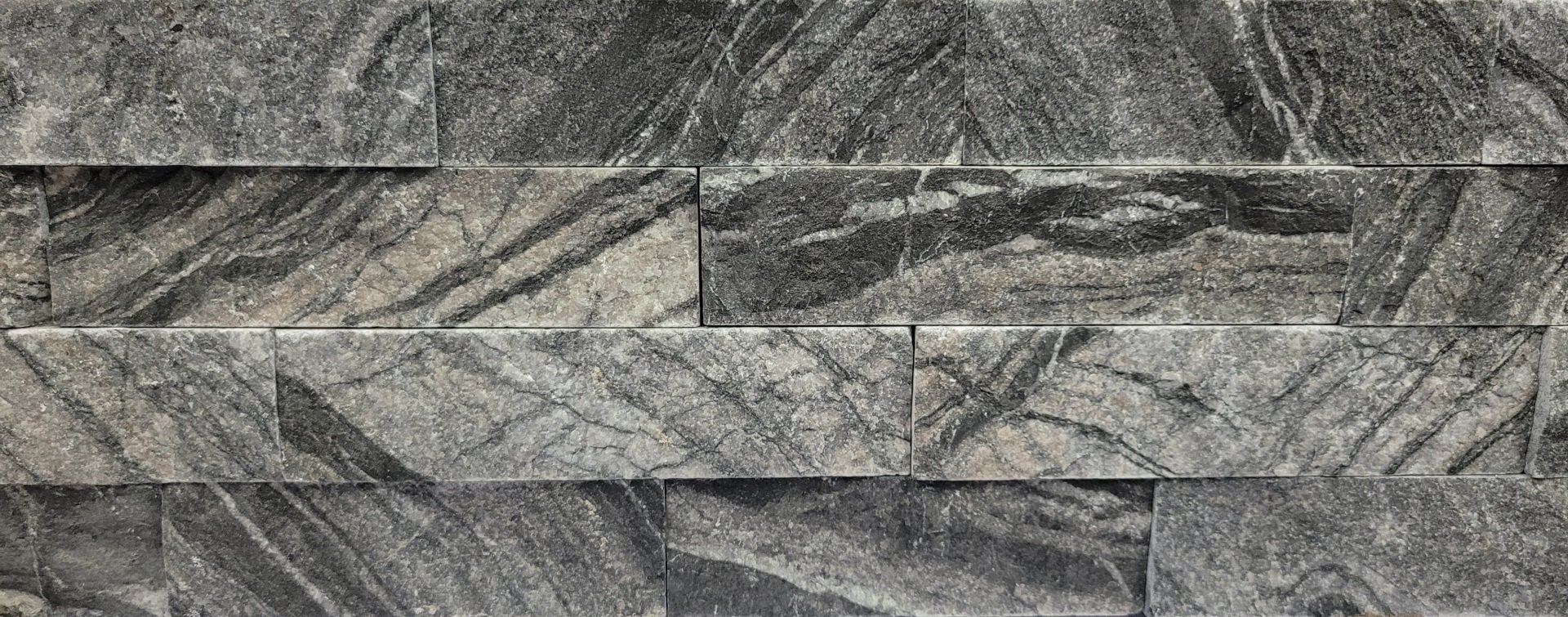 A close up of a brick wall with a pattern on it.