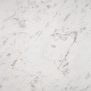 A close up of a white marble counter top.