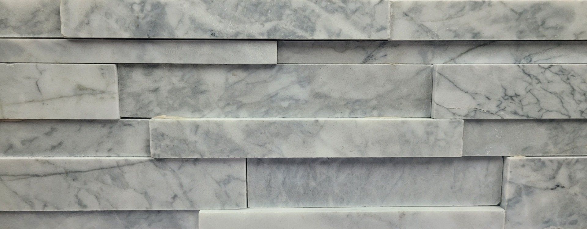 A close up of a white marble wall tile.