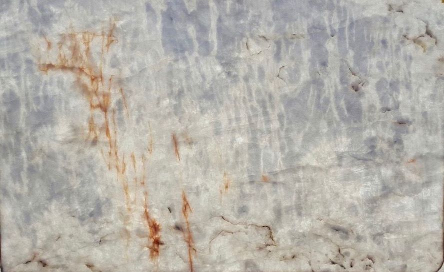 A close up of a rusty metal surface with a marble texture.