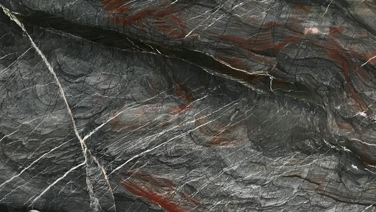 A close up of a black and red marble texture.