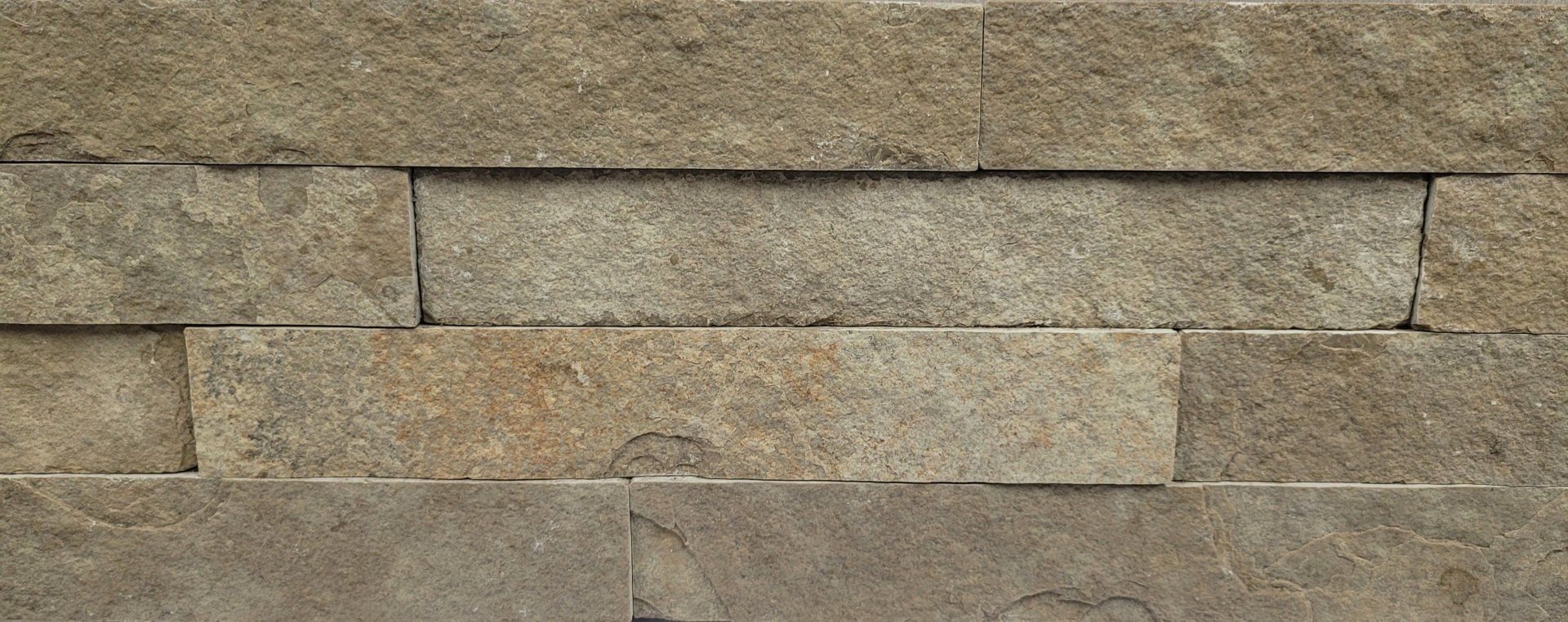 A close up of a brick wall with a few bricks missing.