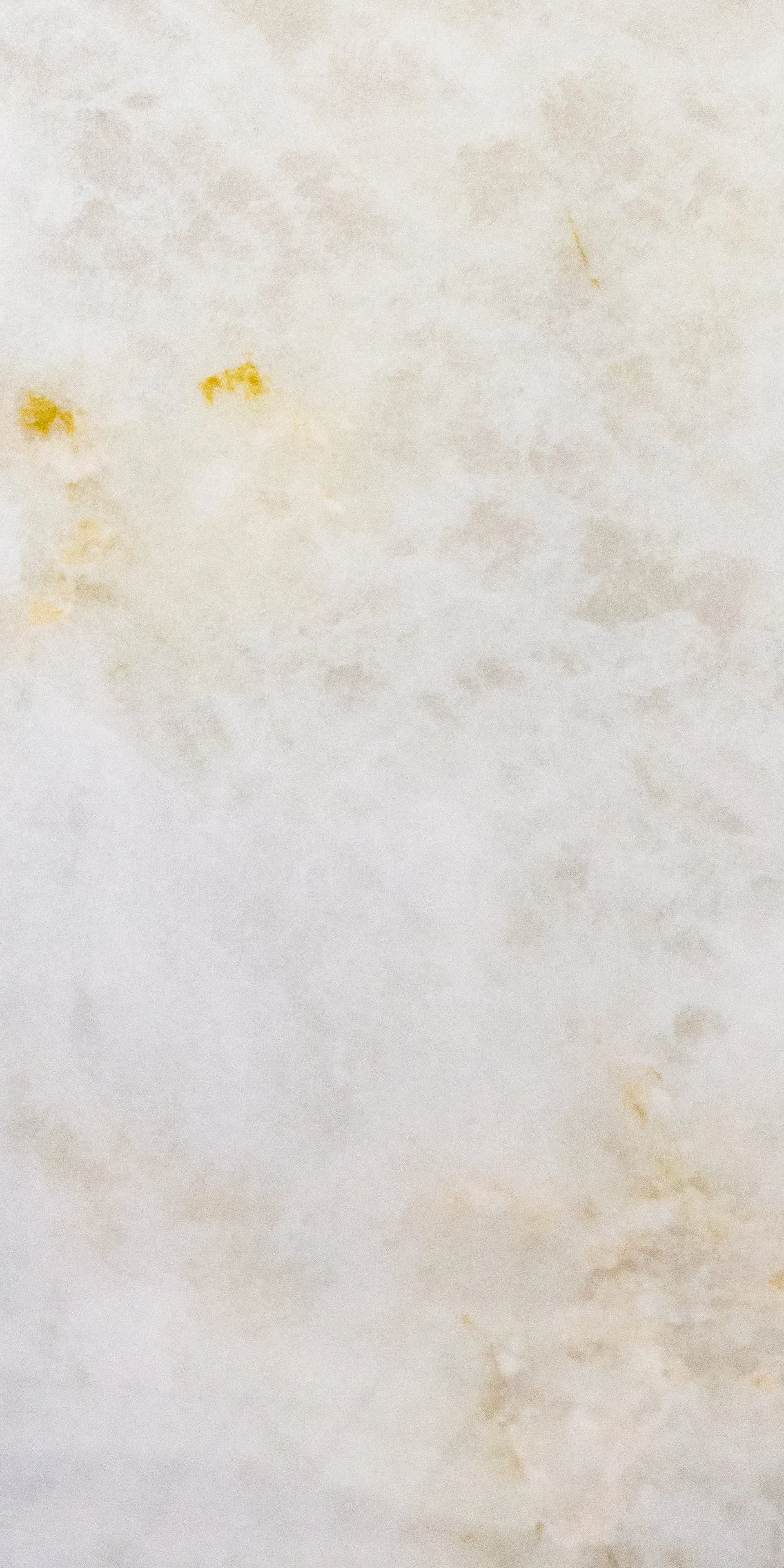 A close up of a white cloth with yellow stains on it.