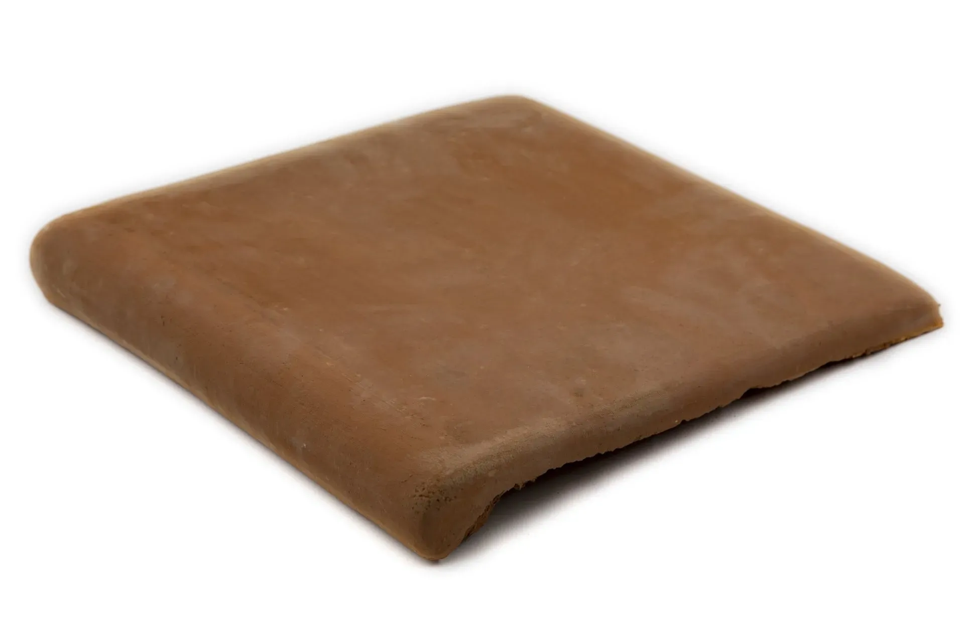 A brown cushion is sitting on a white surface.