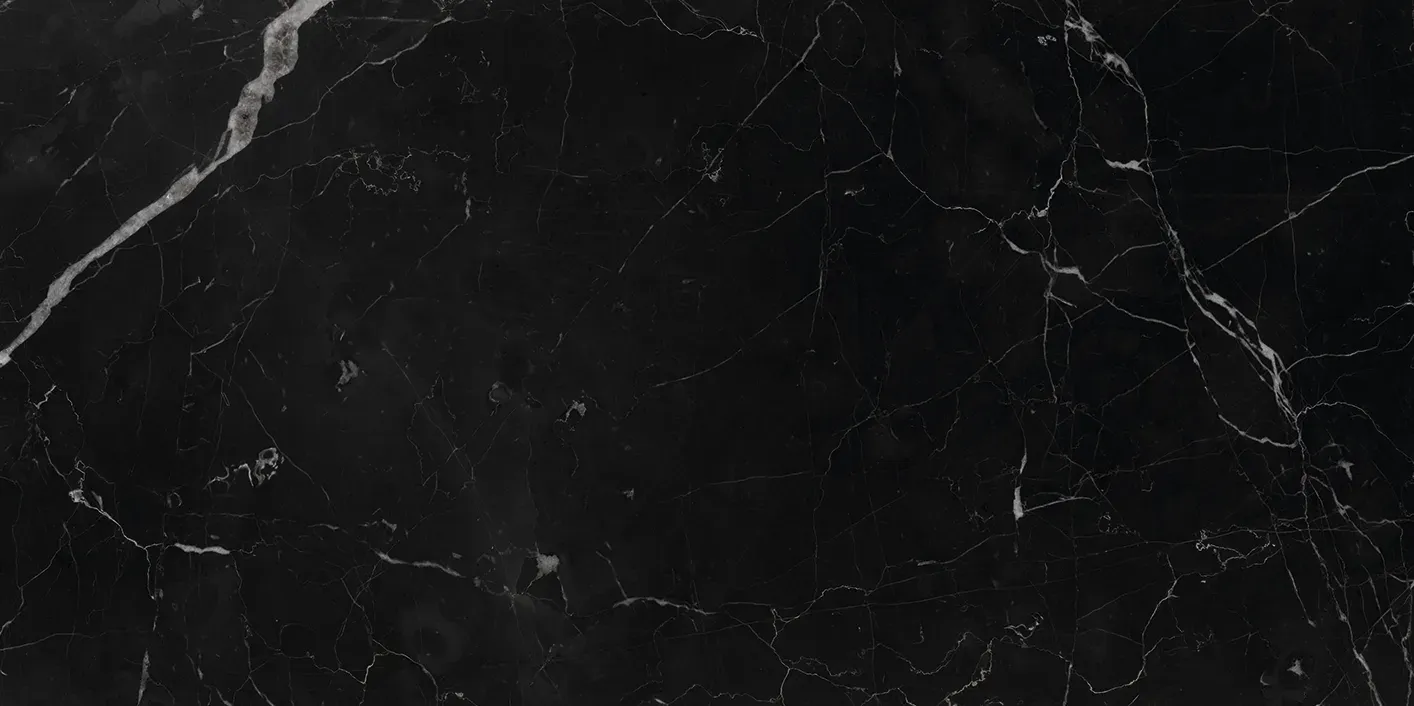 A close up of a black marble texture with white veins.