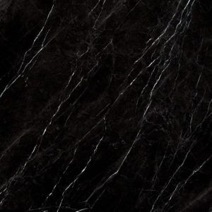 A close up of a black marble tile with white veins.