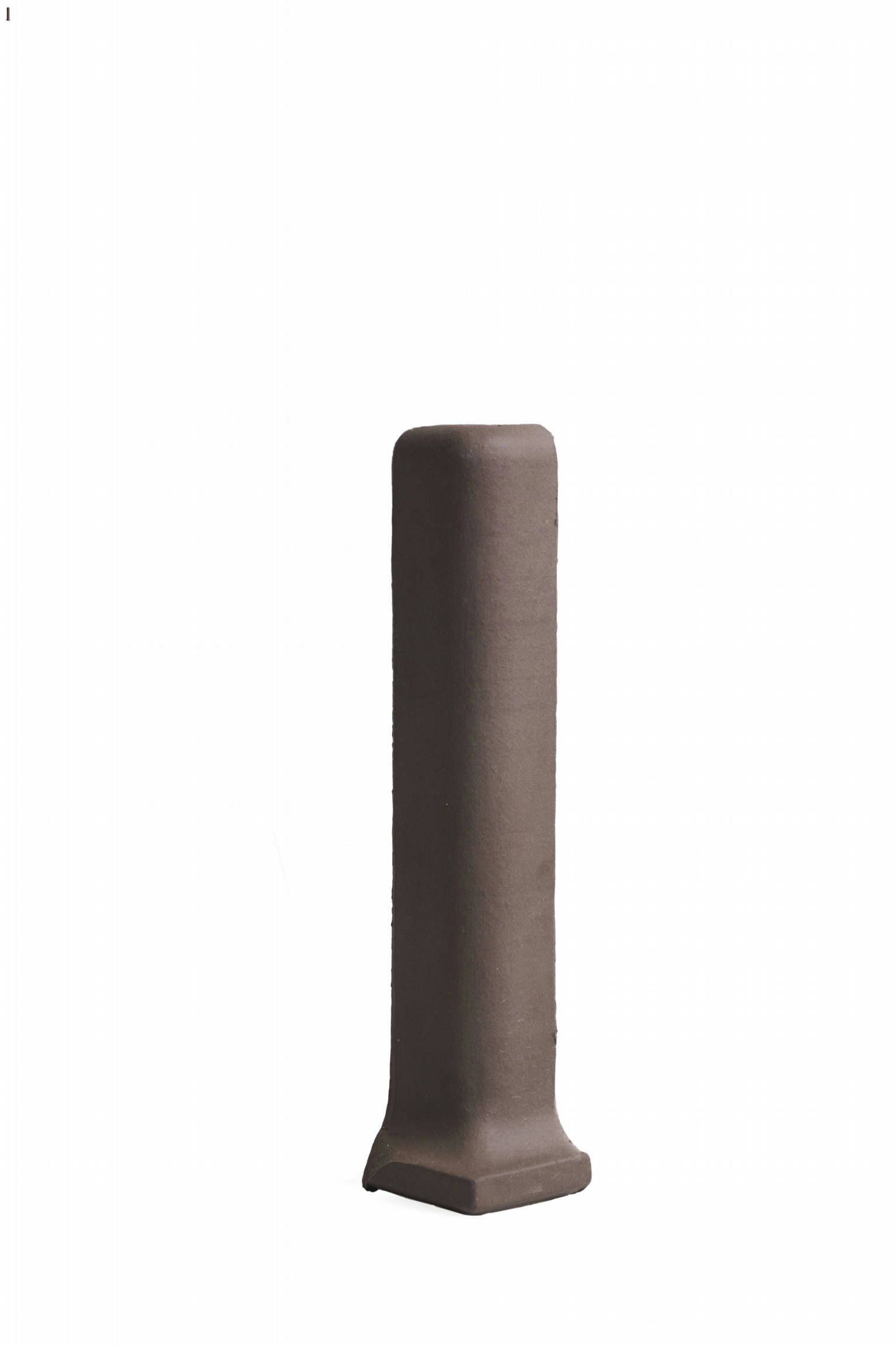 A brown pole is sitting on a white surface.