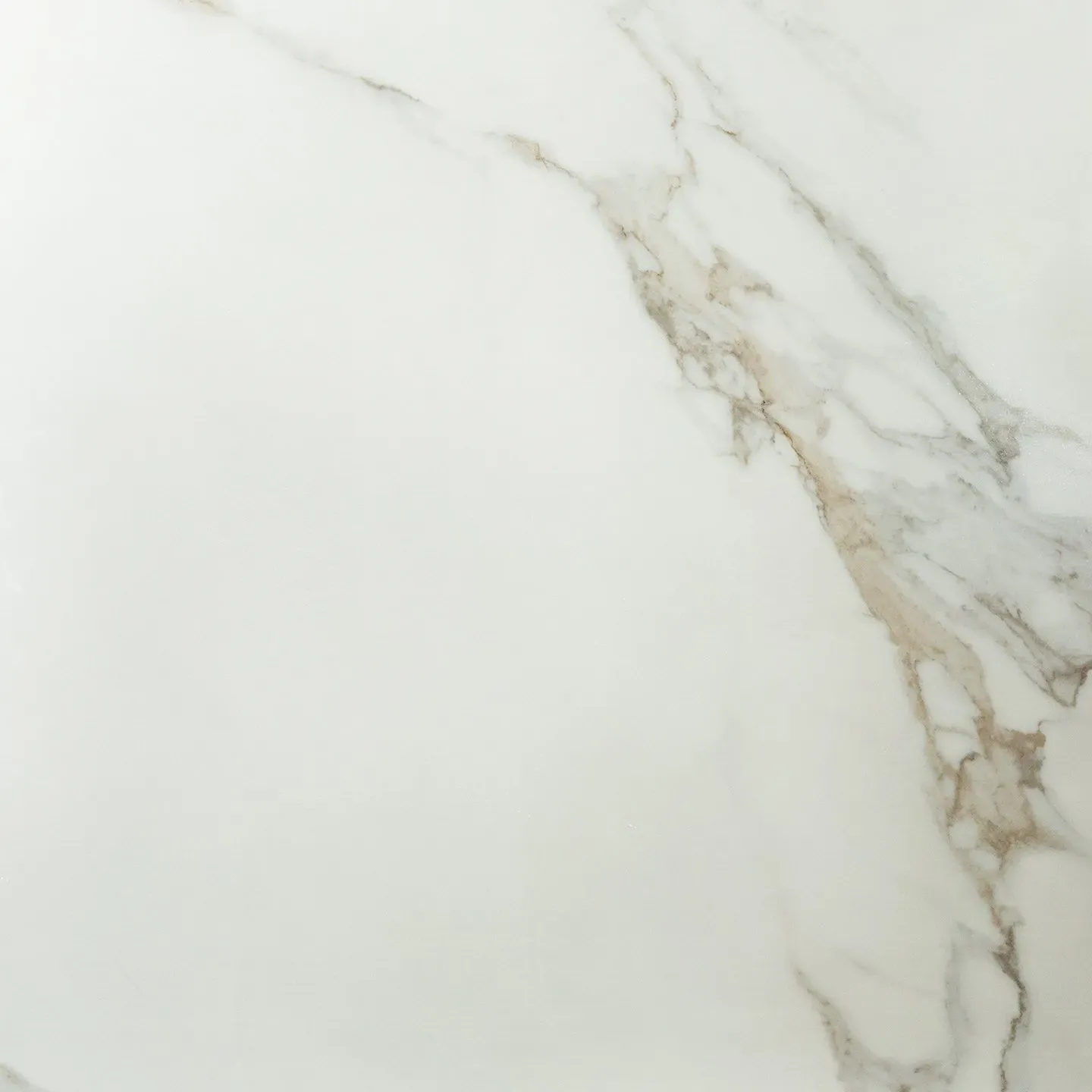 A close up of a white marble tile with a gold vein.