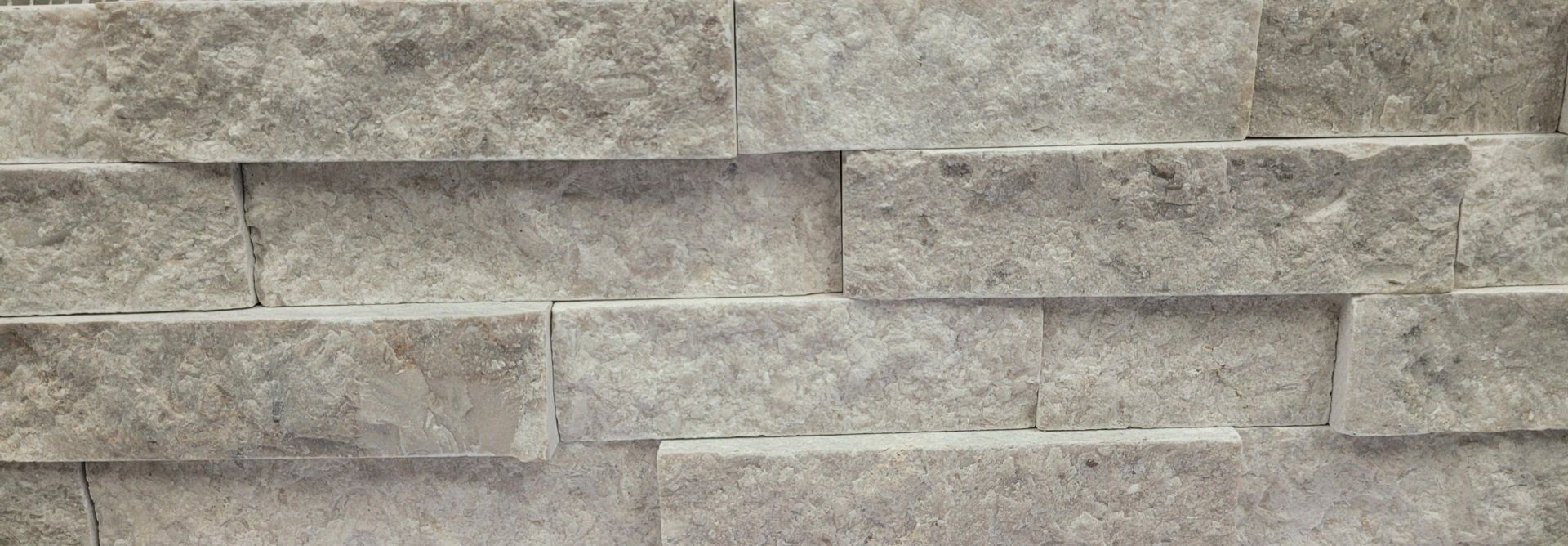 A close up of a brick wall with a lot of bricks on it.