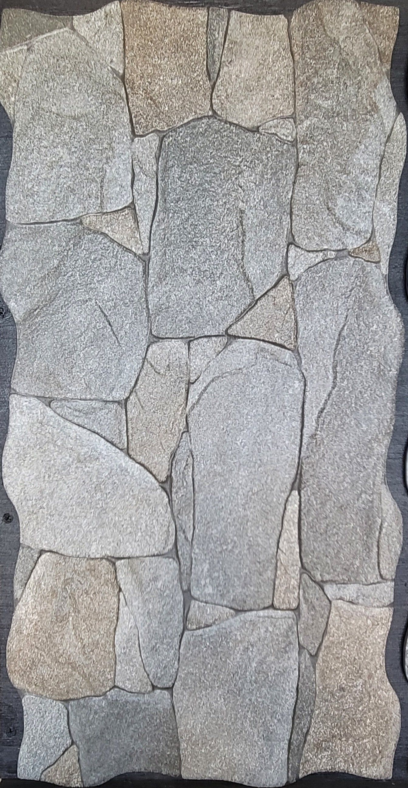 A close up of a piece of stone on a black surface.