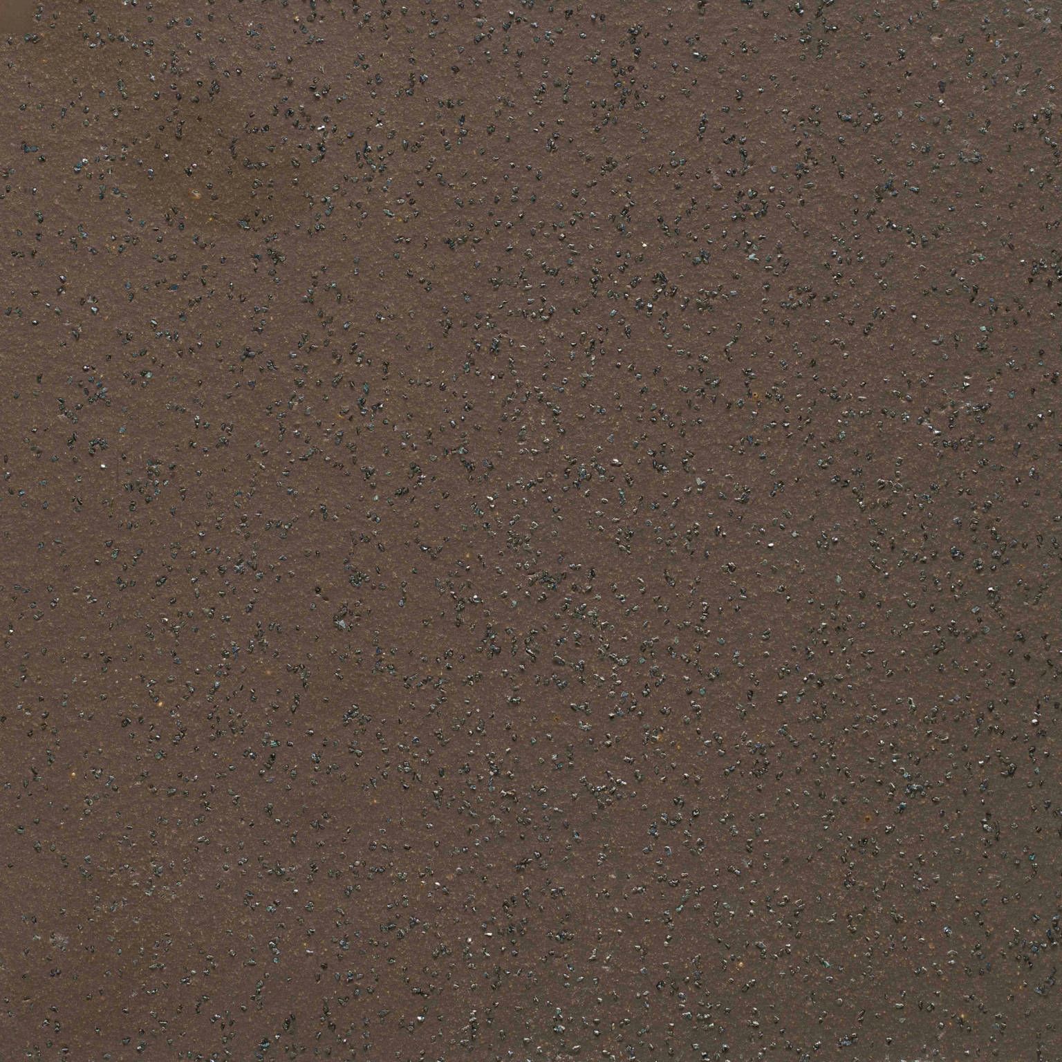A close up of a brown surface with small dots on it