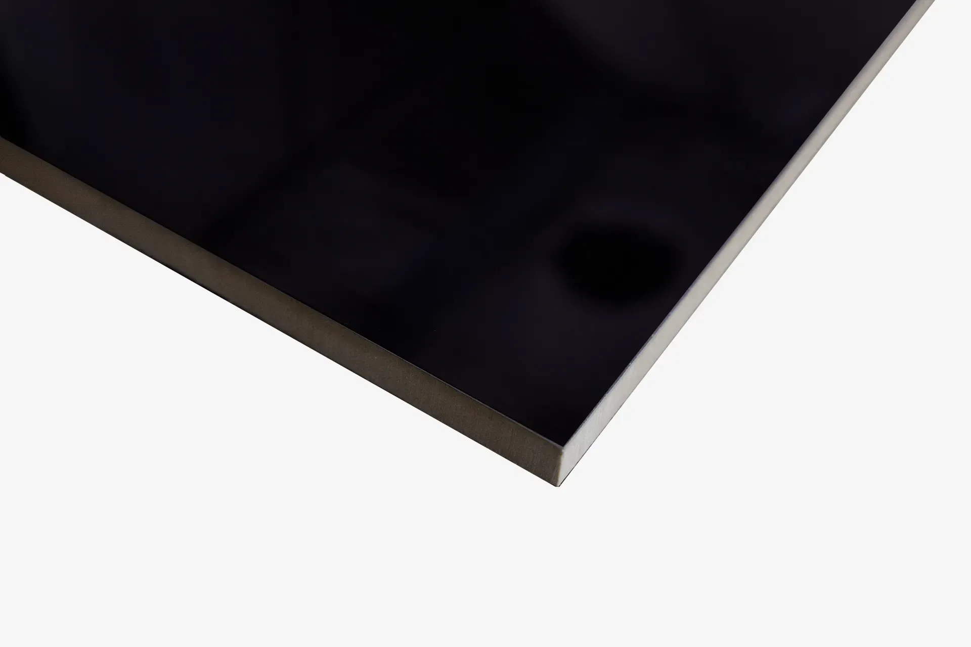 A close up of a black tile on a white background