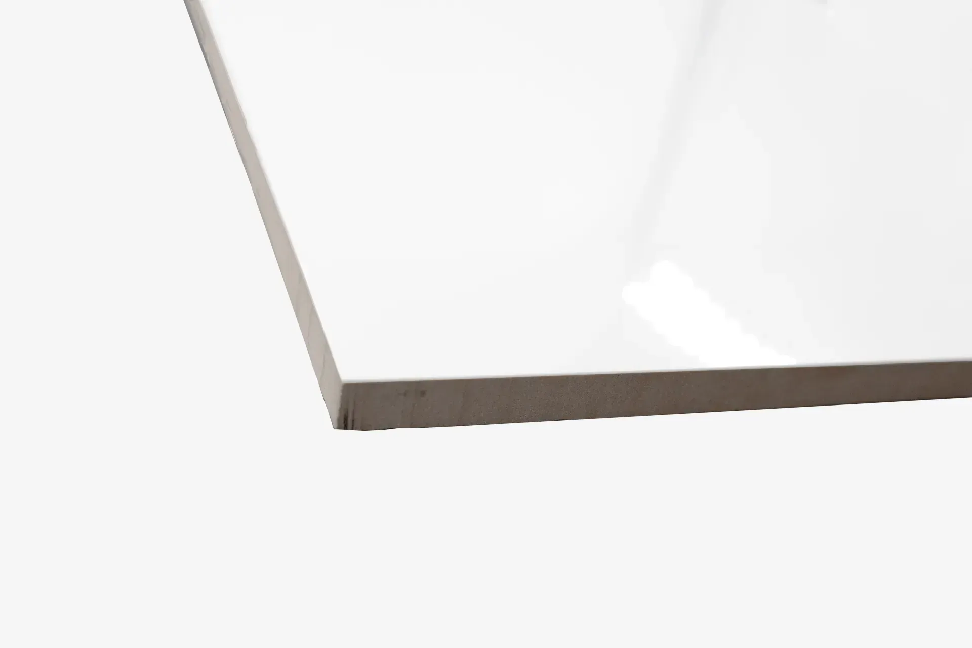 A close up of a white tile on a white background