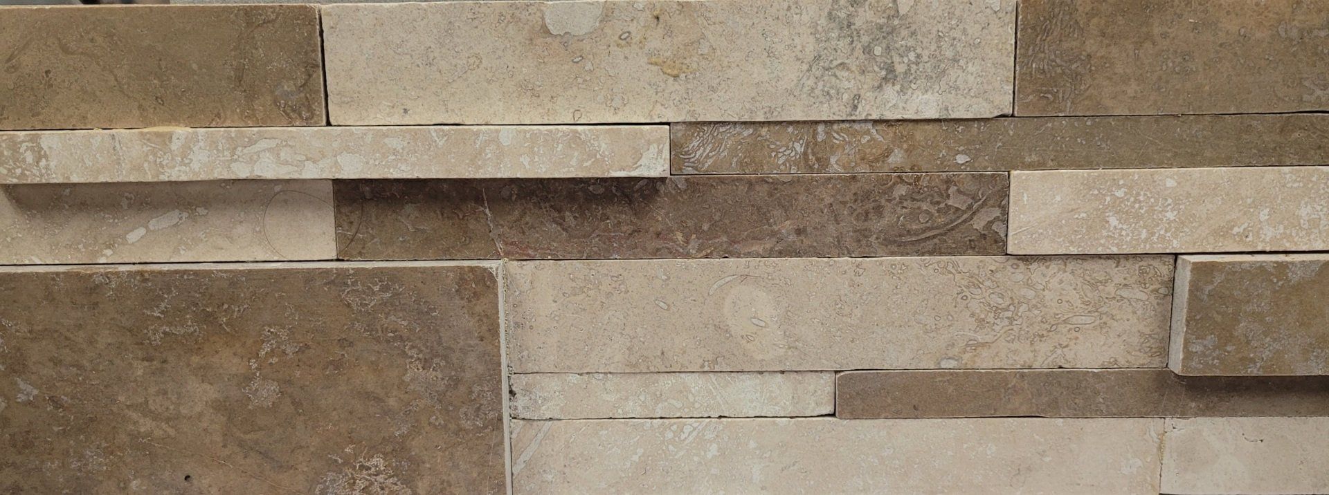 A close up of a wall made of bricks and tiles.