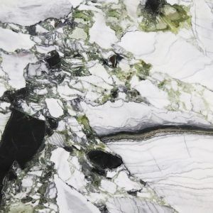 A close up of a white and green marble surface.
