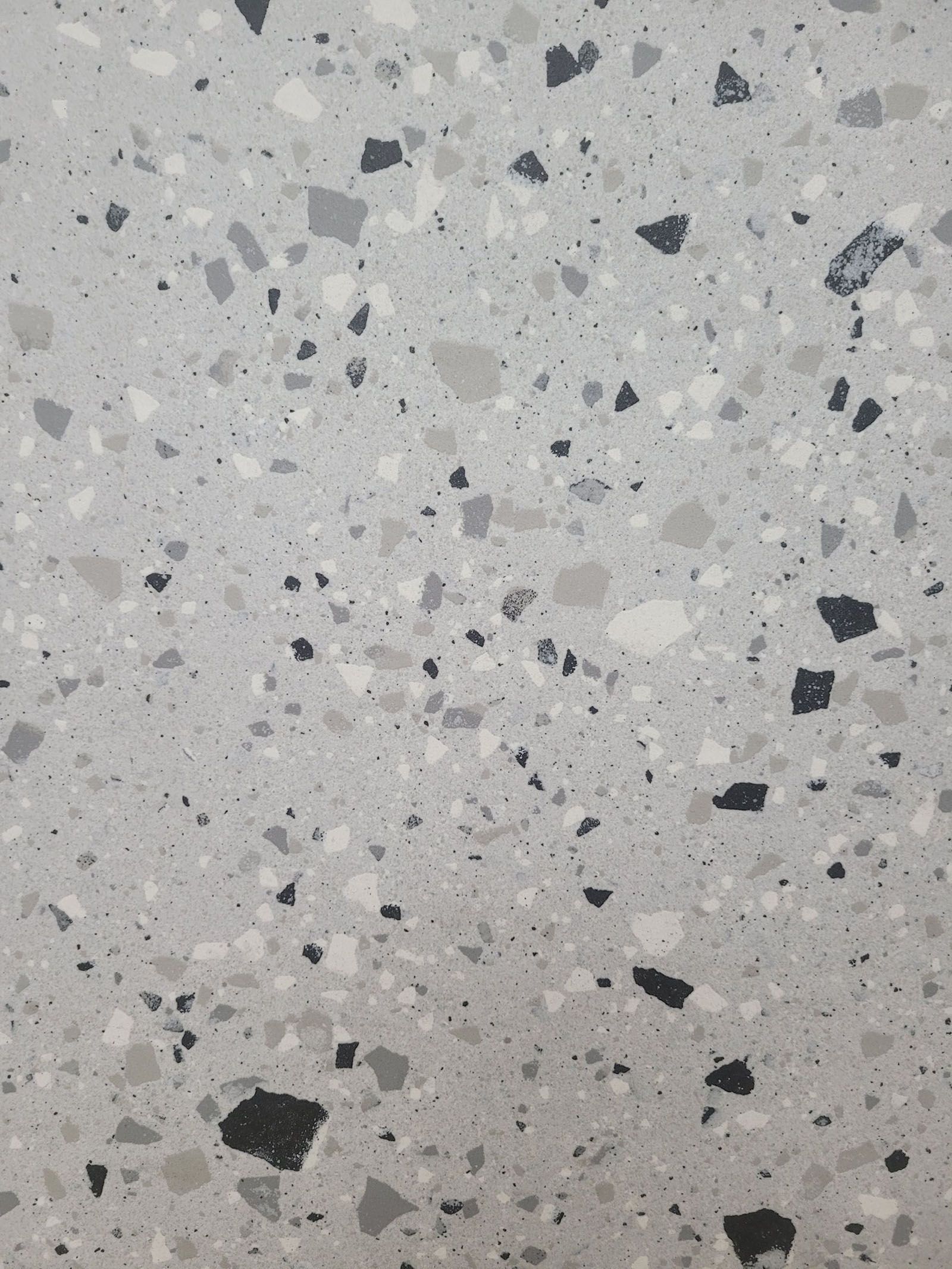 A close up of a gray and black terrazzo floor.