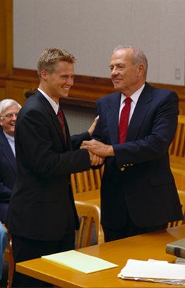 Two men shaking hands in court