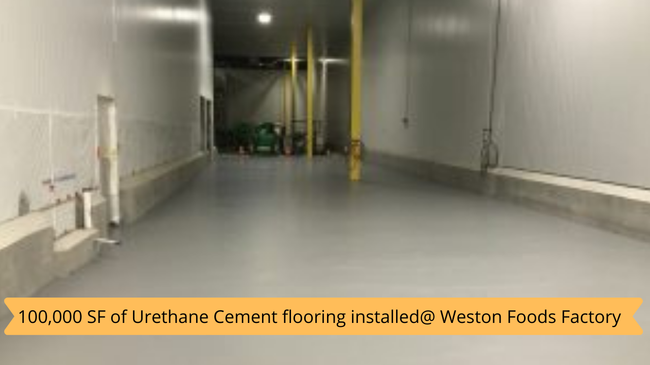 A large empty room with a sign that says 100,000 sf of urethane cement flooring installed at weston foods factory.