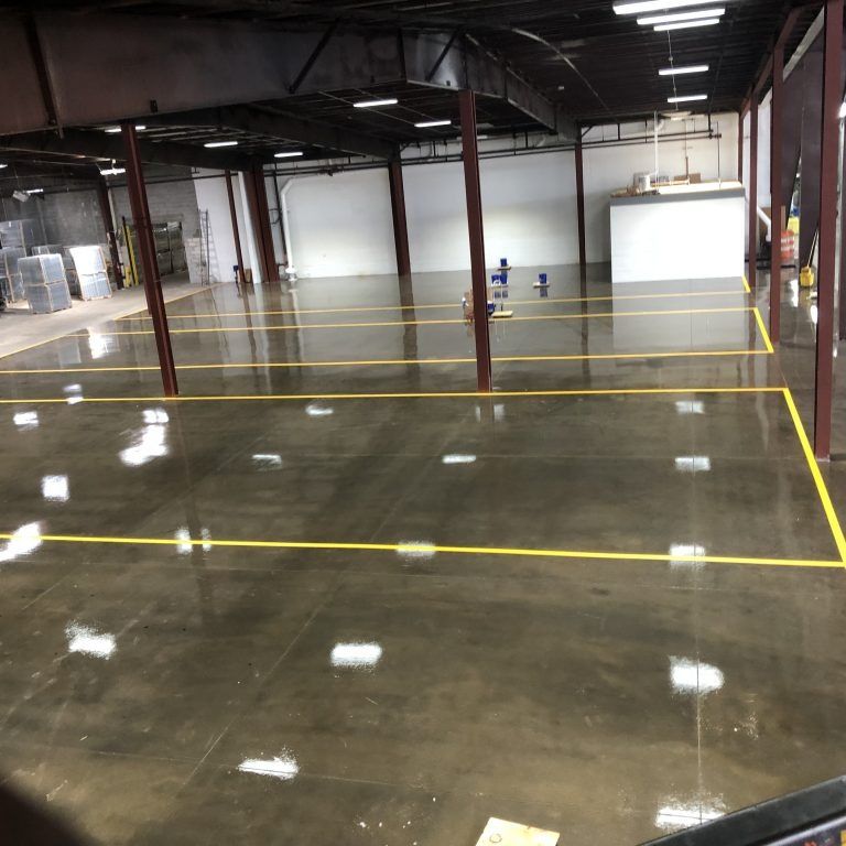 A large empty warehouse with yellow lines on the floor