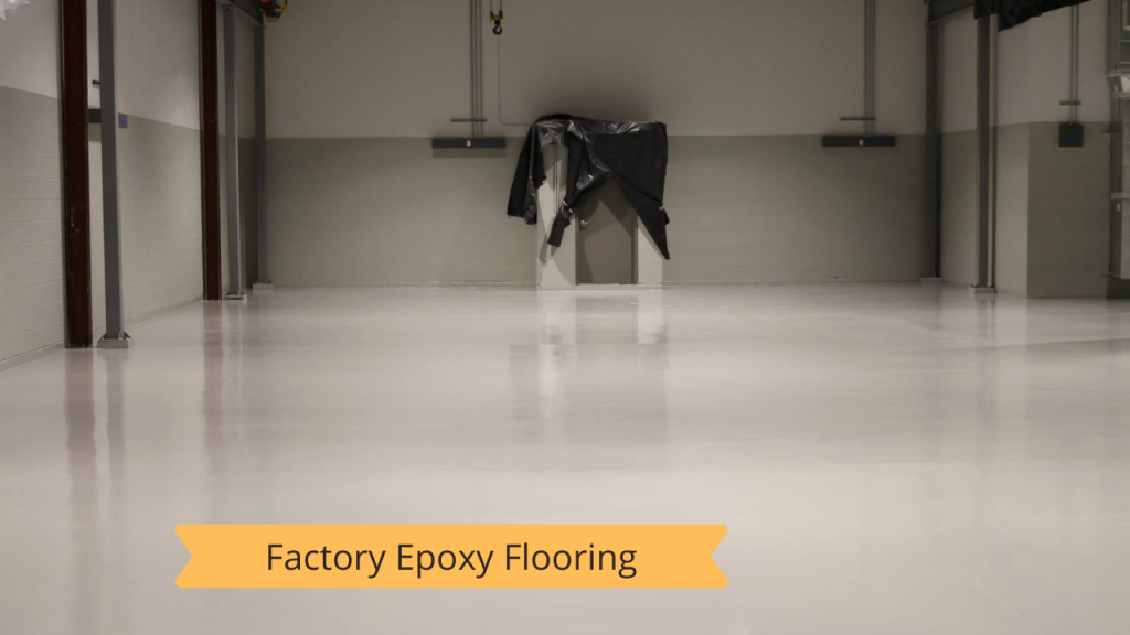 A large empty room with a white floor and a sign that says factory epoxy flooring.