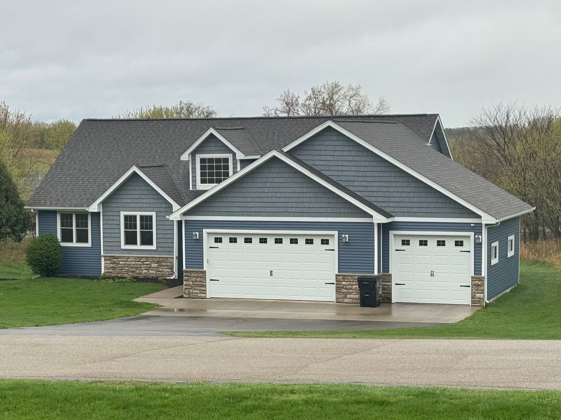 The side of a house with a lot of windows and siding