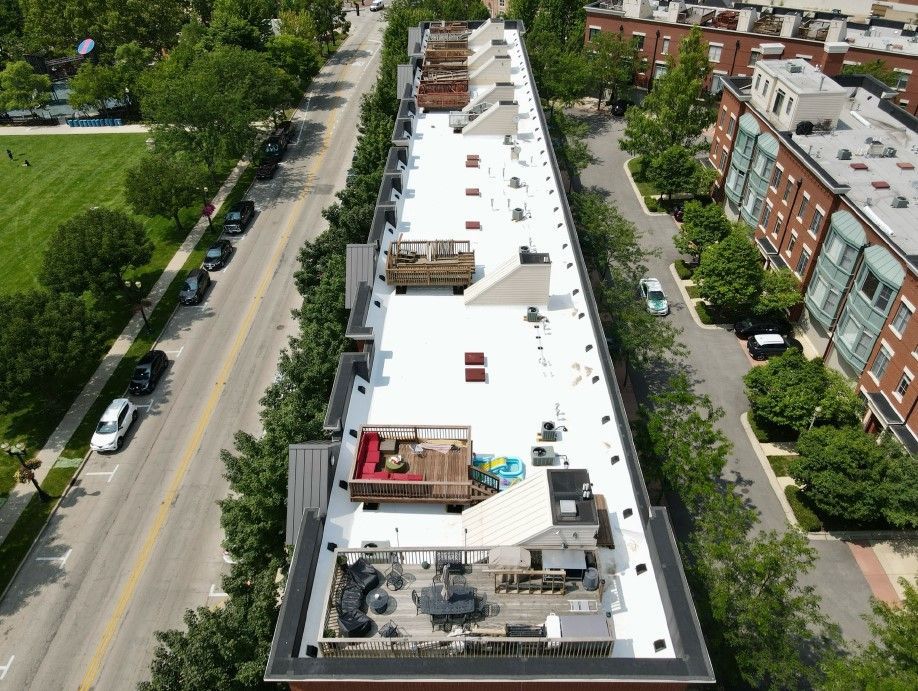 An aerial view of a building with a white roof
