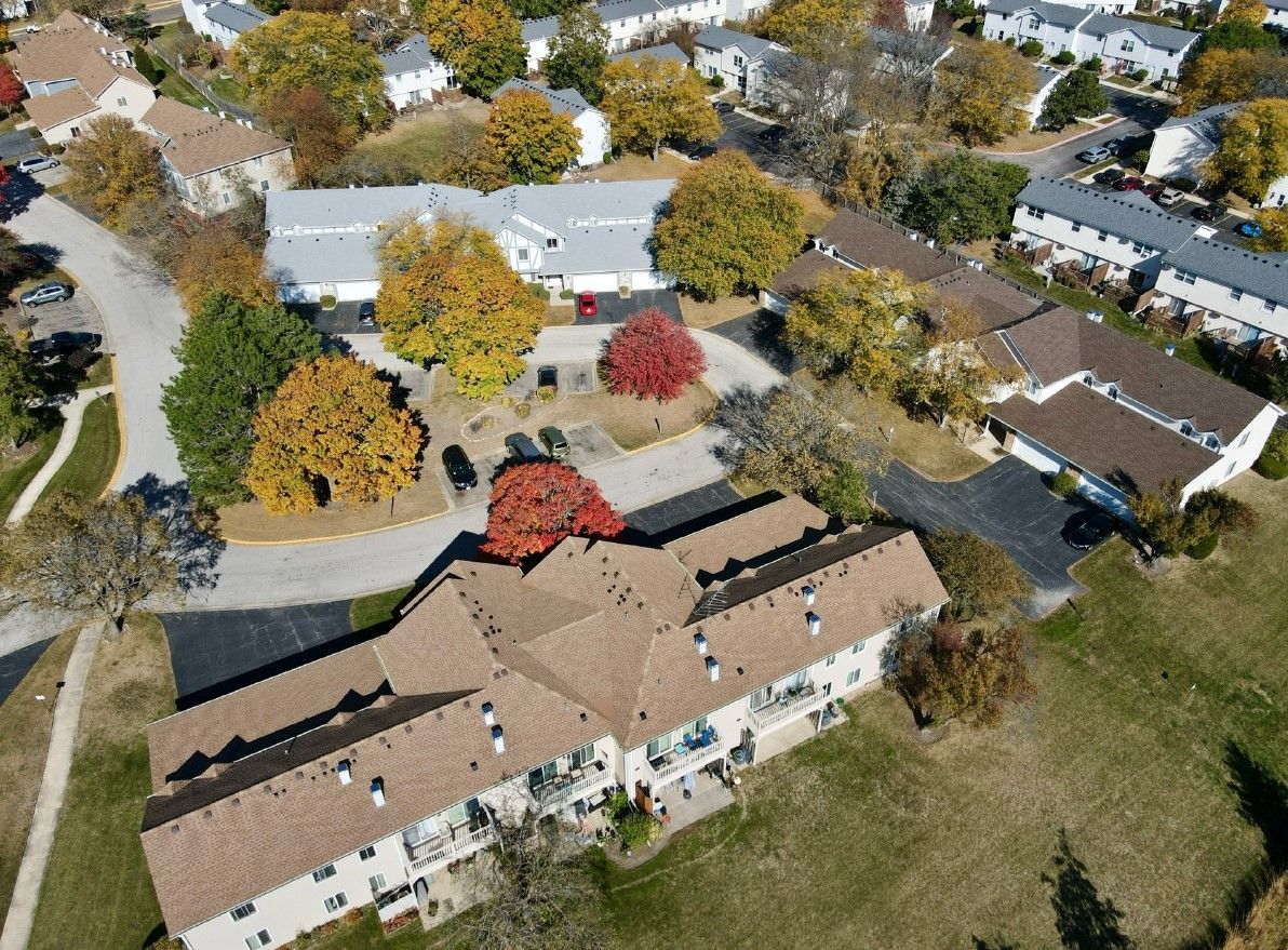 An aerial view of a residential area with houses and trees