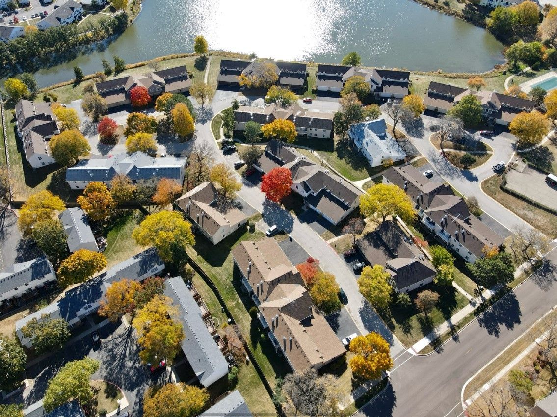 An aerial view of a residential area with a lake in the background