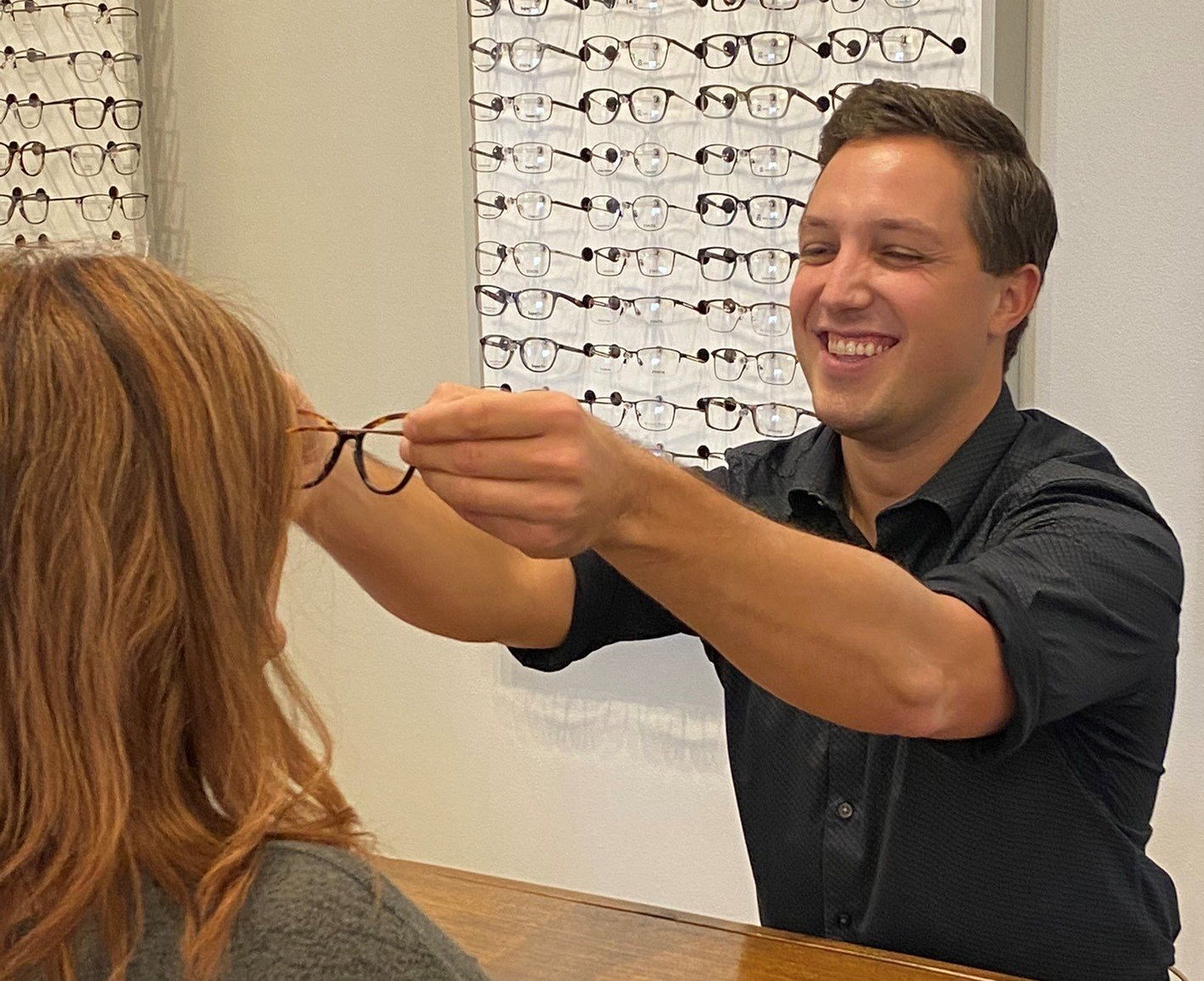 A man is giving a pair of glasses to a woman