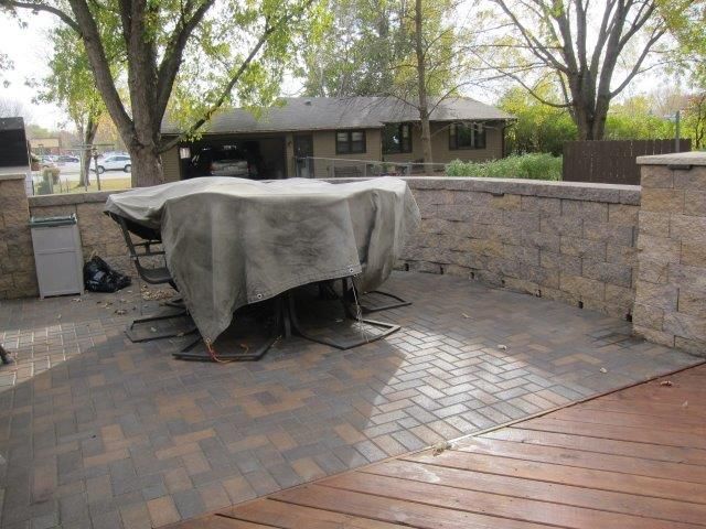 A patio with a table and chairs covered in a tarp