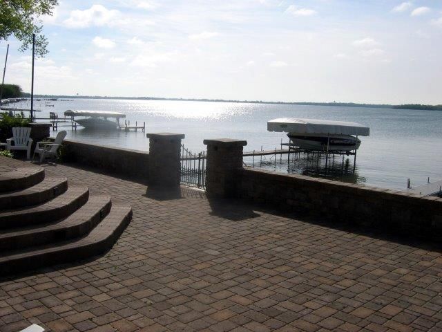 A view of a lake from a brick patio