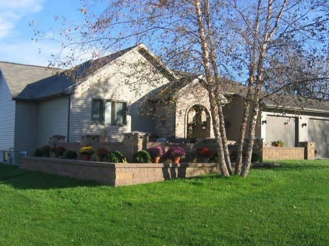 A house with a large lawn in front of it