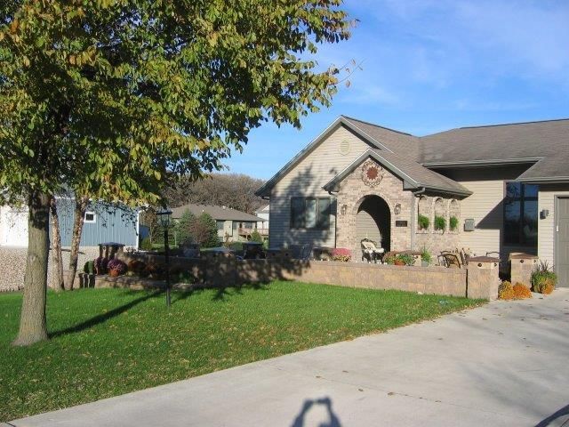 A house with a tree in front of it on a sunny day