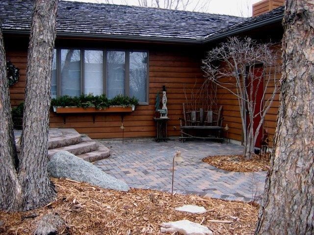 A house with a patio and a bench in front of it