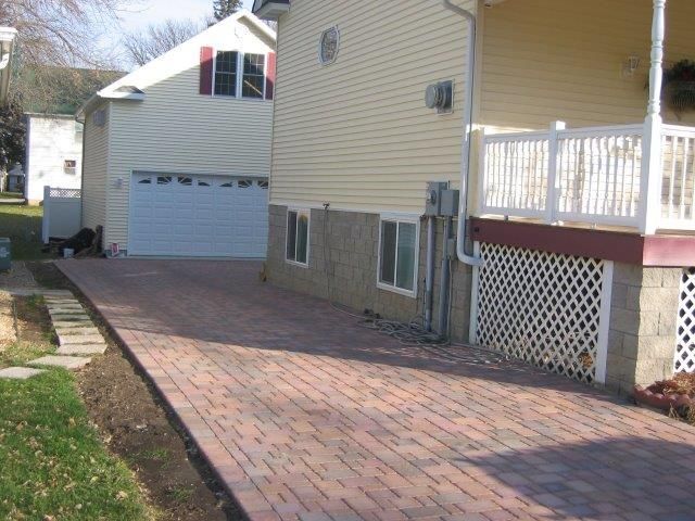 A house with a brick driveway leading to it