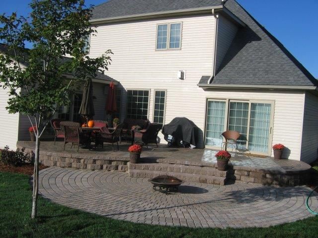 A large white house with a patio in front of it