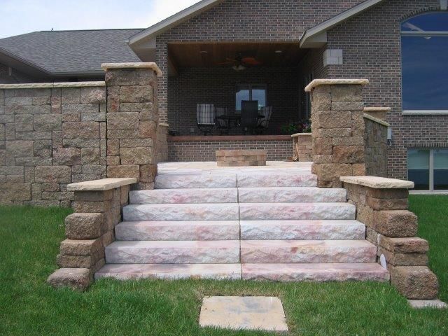 A set of stairs leading up to a brick house